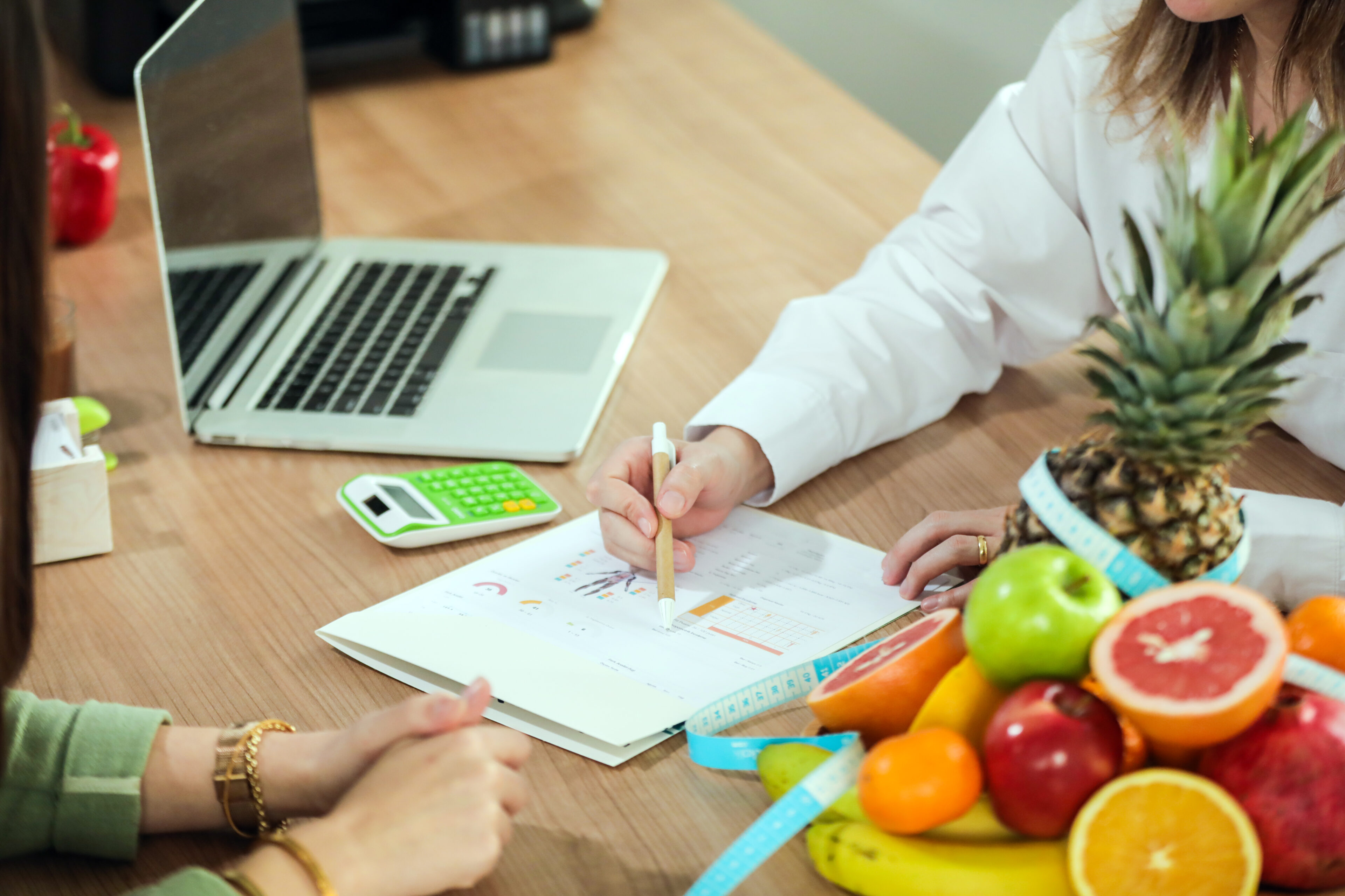 Nutrition consultation with fruits and notepad.