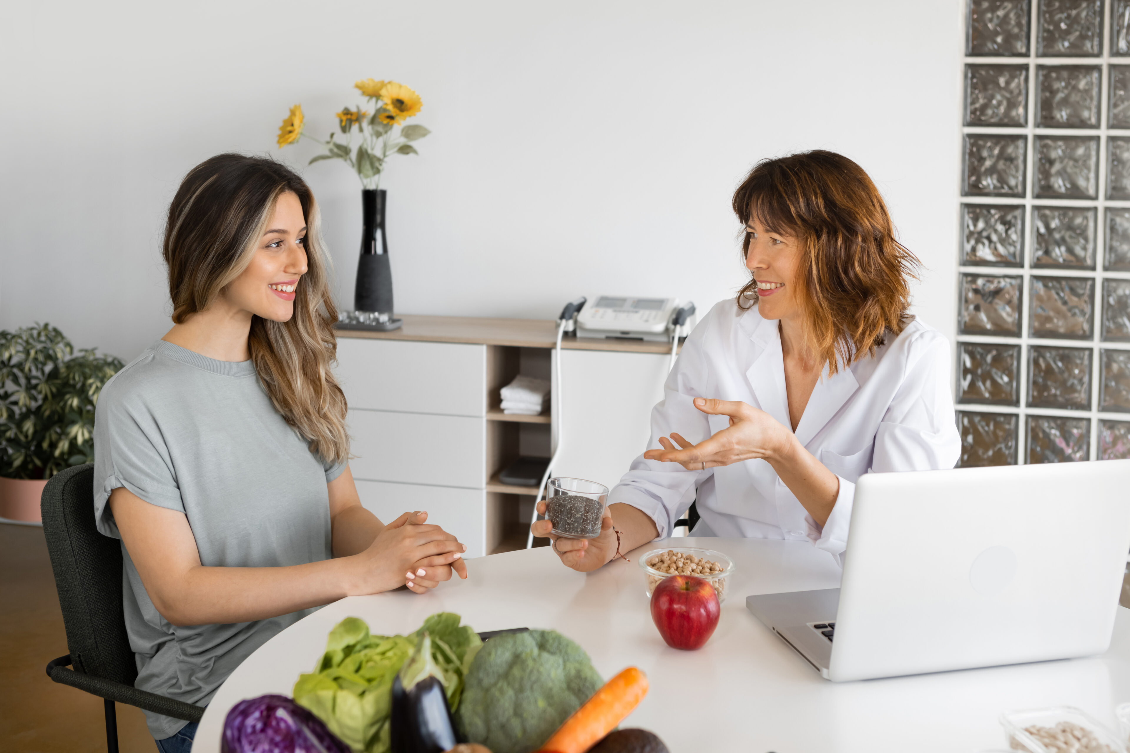 Two women talking at a table.