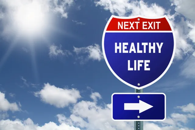A blue and white road sign with an arrow pointing to the right.
