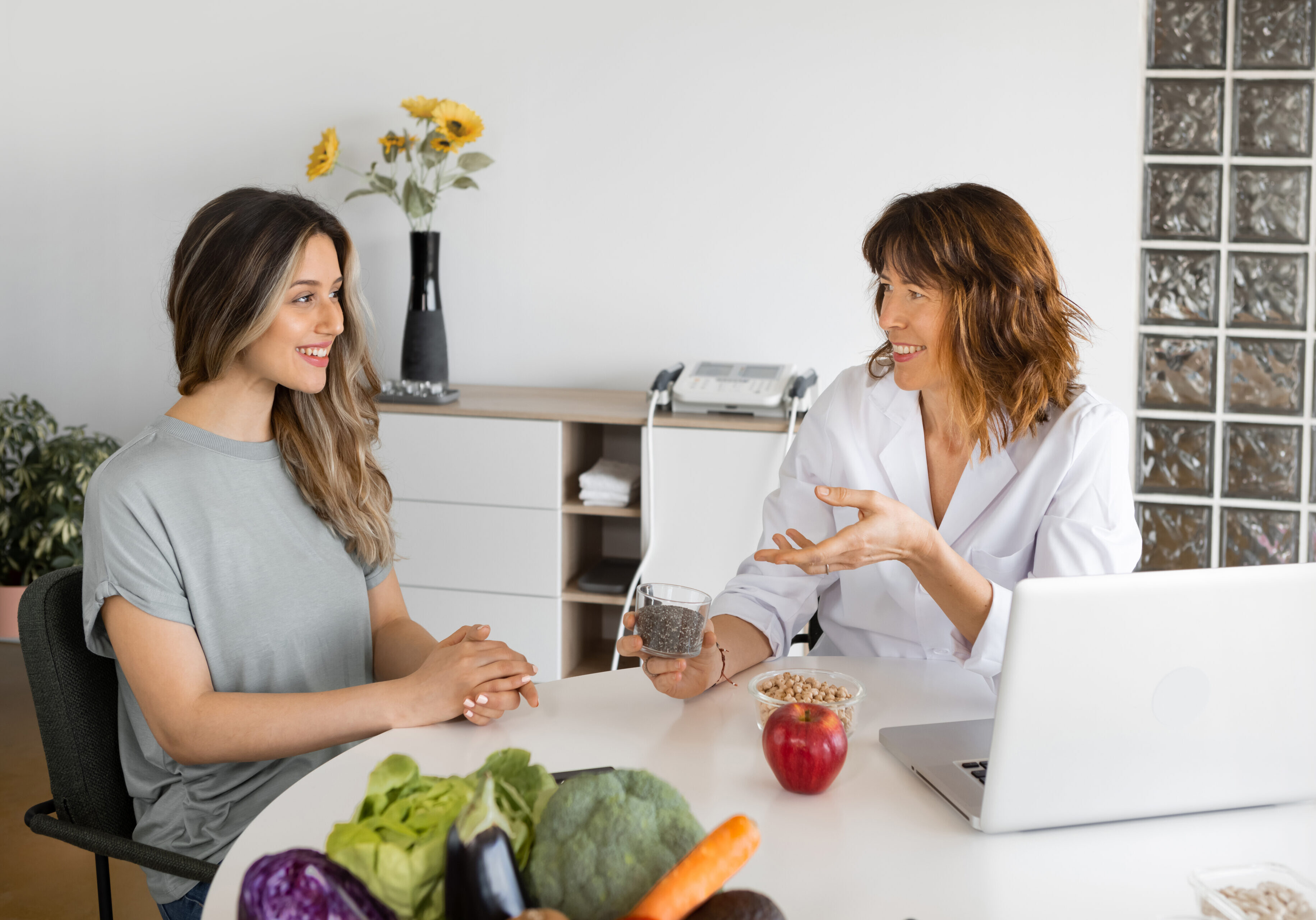 Two women talking at a table.